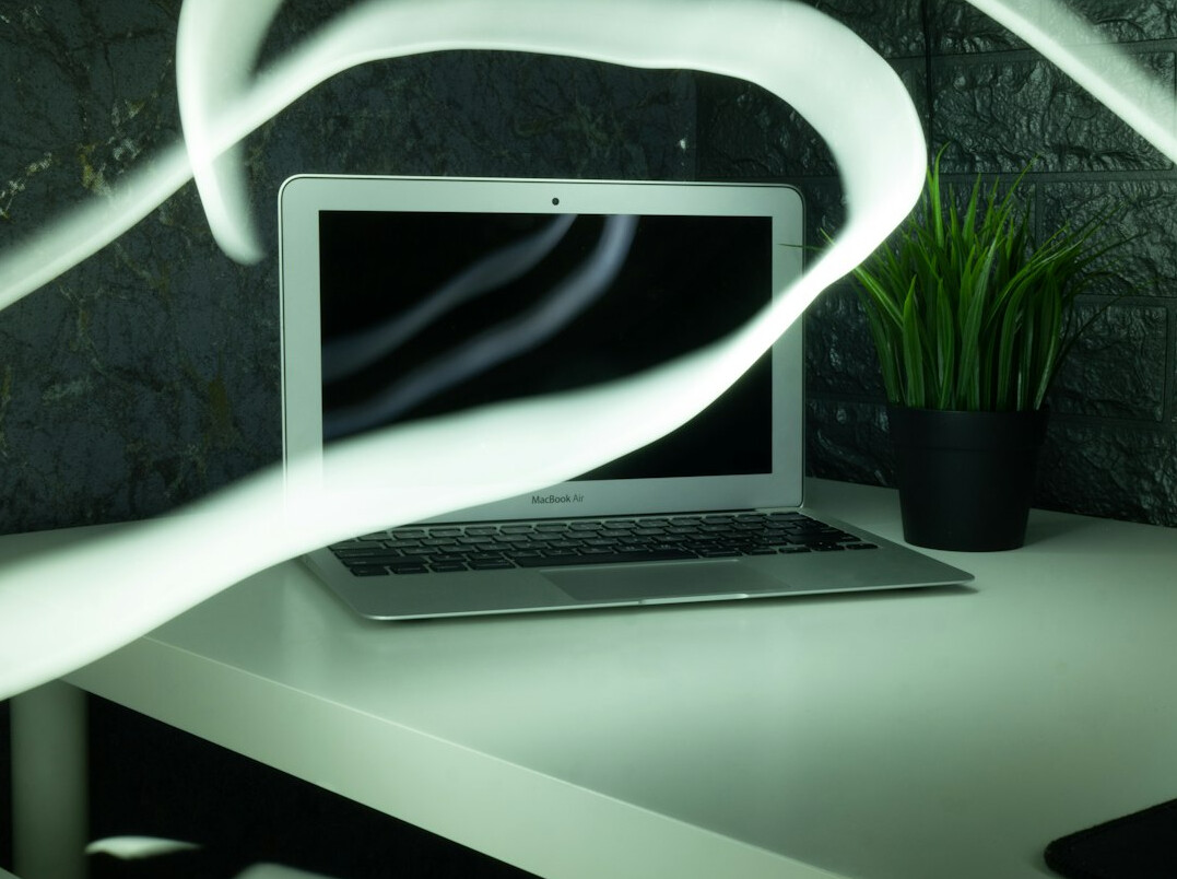 Laptop with code and a coffee on a desk